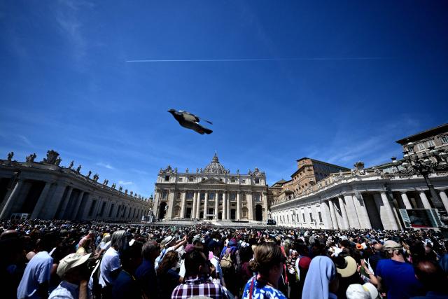 Pope Leo XIV addresses the crowd from a window of the Apostolic Palace overlooking St. Peter's Square during the Regina Caeli prayer in the Vatican on May 3, 2026. (Photo by TIZIANA FABI / AFP)