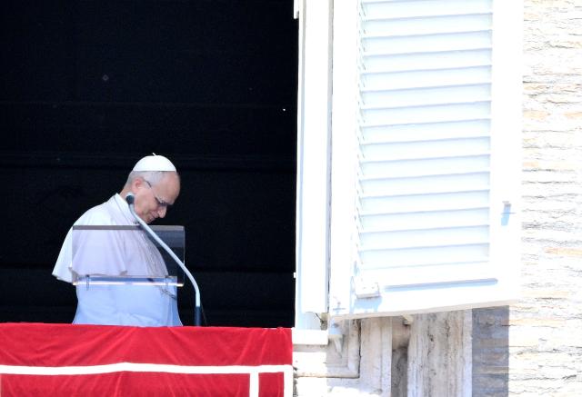Pope Leo XIV stands at a window of the Apostolic Palace overlooking St. Peter's Square after the Regina Coeli prayer in the Vatican on May 3, 2026. (Photo by TIZIANA FABI / AFP)