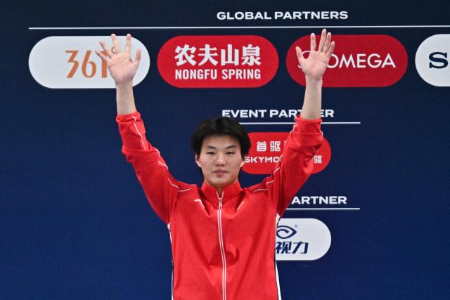 China’s Bai Yuming celebrates on the podium after winning the men’s 10m platform event at the World Aquatics Diving World Cup Super Finals in Beijing on May 3, 2026. (Photo by Pedro PARDO / AFP)
