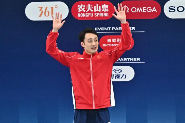 China’s Lian Junjie celebrates on the podium after finishing third in the men’s 10m platform event at the World Aquatics Diving World Cup Super Finals in Beijing on May 3, 2026. (Photo by Pedro PARDO / AFP)