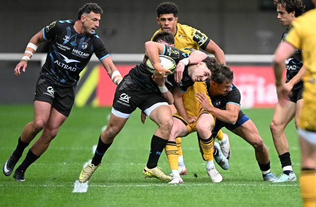 Montpellier’s French wing Melvyn Rates (C) is tackled  during the European Challenge Cup rugby union semi-final match between Montpellier Herault Rugby and Dragons RFC at the Septeo Stadium in Montpellier, southern France, on May 3, 2026. (Photo by Gabriel BOUYS / AFP)