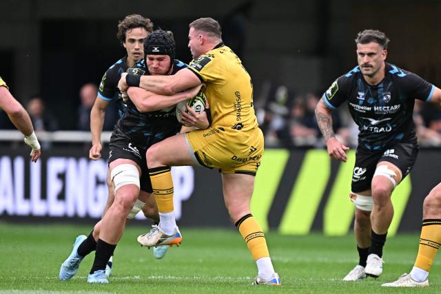 Montpellier’s French number eight Lenni Nouchi (L) is tackled by Dragon's Welsh hooker Elliot Dee  during the European Challenge Cup rugby union semi-final match between Montpellier Herault Rugby and Dragons RFC at the Septeo Stadium in Montpellier, southern France, on May 3, 2026. (Photo by Gabriel BOUYS / AFP)