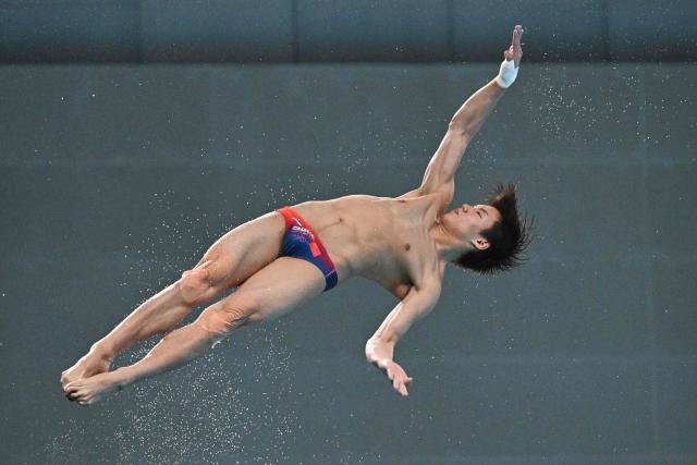 China’s Bai Yuming competes in the men’s 10m platform event at the World Aquatics Diving World Cup Super Finals in Beijing on May 3, 2026. (Photo by Pedro PARDO / AFP)