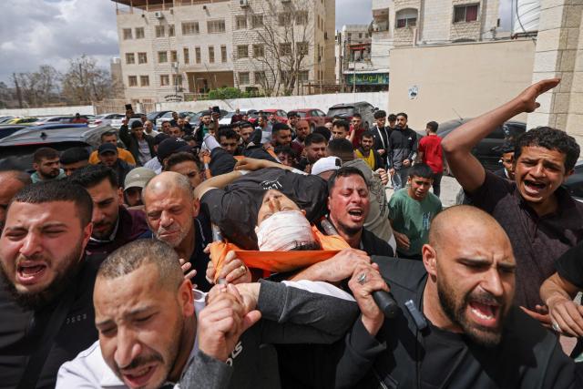 EDITORS NOTE: Graphic content / Mourners carry the body of a Palestinian man, who was allegedly killed in clashes with Israeli soldiers during a raid in the Israeli-occupied West Bank city of Nablus on May 3, 2026. Violence has surged in the Palestinian territory since the start of the war in Gaza in October 2023. According to an AFP tally based on Palestinian health ministry figures, Israeli troops or settlers have killed at least 1,068 Palestinians -- many of them militants, but also scores of civilians -- in the West Bank since then. Official Israeli figures say at least 46 Israelis, including soldiers and civilians, have been killed in Palestinian attacks or during Israeli military operations in the same period. (Photo by JAAFAR ASHTIYEH / AFP)
