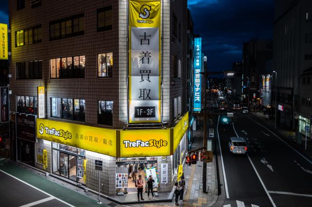 People stand in front of a used clothing shop in Kawagoe city in Saitama Prefecture during the Golden Week holiday on May 3, 2026. (Photo by Philip FONG / AFP)