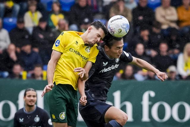 Fortuna Sittard's Indonesian defender #28 Justin Hubner (L) and Feyenoord's Japanese forward #09 Ayase Ueda jump for the ball during the Dutch Eredivisie football match between Fortuna Sittard and Feyenoord at the Fortuna Sittard stadium in Sittard on May 3, 2026. (Photo by Tobias Kleuver / ANP / AFP) / Netherlands OUT