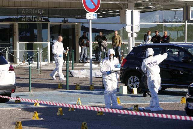 (FILES) Forensic police work at the scene of a deadly shooting near the body of Antoine Quilichini, aka Tony le boucher (Tony the butcher), who is on police record for organised crime, outside the airport of Bastia, on the French Mediterranean island of Corsica, on December 5, 2017. The appeal trial for the double murder committed at Bastia-Poretta airport in 2017 starts on May 4, 2026 in Aix-en-Provence, southern France, and will last until July 3, 2026. (Photo by PASCAL POCHARD-CASABIANCA / AFP)
