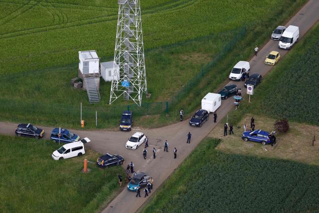 An aerial view shows gendarmes carrying out checks as partygoers leave the site of a @teknival" rave party at a military site in Cornusse, near Bourges, central France on May 3, 2026. Between 17,000 and 40,000 people participate in the free party which has been taking place, without major incident, since May 1, 2026. The gathering comes as the French parliament is seeking to tighten legislation against unauthorised rave parties, introducing prison sentences for organisers and fines for attendees. (Photo by Kenzo TRIBOUILLARD / AFP)