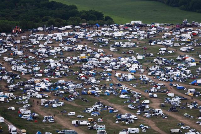 An aerial view shows the site of a "teknival" rave party at a military site in Cornusse, near Bourges, central France on May 3, 2026. Between 17,000 and 40,000 people participate in the free party which has been taking place, without major incident, since May 1, 2026. The gathering comes as the French parliament is seeking to tighten legislation against unauthorised rave parties, introducing prison sentences for organisers and fines for attendees. (Photo by Kenzo TRIBOUILLARD / AFP)