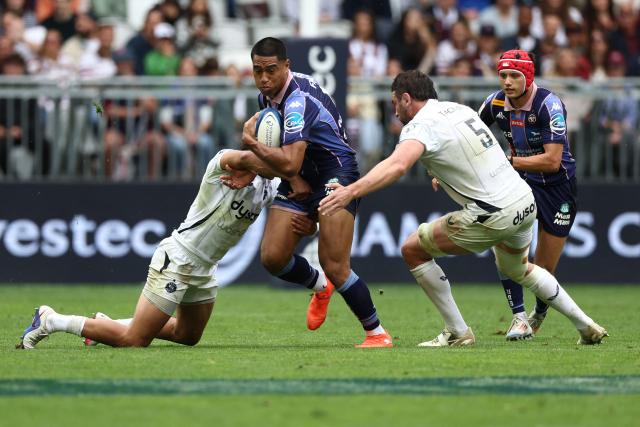 Bordeaux-Begles' New-Zealand wing Salesi Rayasi (C) is tackled during the European Champions Cup semi-final rugby union match between Union Bordeaux Belges (UBB) and Bath Rugby at the Atlantique Bordeaux Metropole Stadium in Bordeaux, southwestern France, on May 3, 2026. (Photo by ROMAIN PERROCHEAU / AFP)