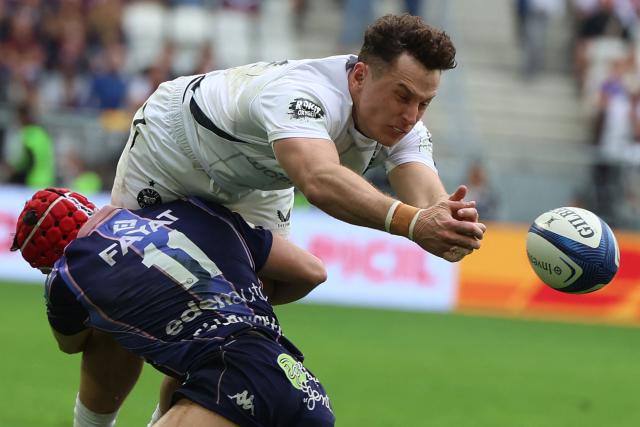 Bordeaux-Begles' French full-back Louis Bielle-Biarrey (L) tackles Bath's Welsh centre Louie Hennessey (R) during the European Champions Cup semi-final rugby union match between Union Bordeaux Belges (UBB) and Bath Rugby at the Atlantique Bordeaux Metropole Stadium in Bordeaux, southwestern France, on May 3, 2026. (Photo by ROMAIN PERROCHEAU / AFP)