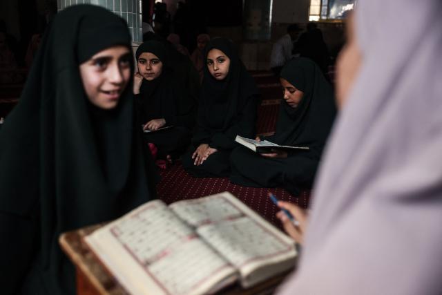A Palestinian, one of the 470 Palestinian girls and young women attends a Quran recitation circle at the Al-Nour Quran Memorization Center following a long hiatus due to the war between the Israeli military and Palestinian Hamas militants, in Khan Yunis in the southern Gaza Strip on May 3, 2026. The Quran recitation study circle gathers the faithful around a teacher or a shared text for the purpose of learning, recitation, discussion, or spiritual development. The war on the Gaza Strip was sparked following the militant Palestinian group Hamas's October 7, 2023 attack on Israel, which resulted in the deaths of 1,221 people. Israel's retaliatory assault on Gaza has killed at least 72,600 people, according to figures from the health ministry that the UN considers reliable, with the majority of Gaza's 2.4 million people being displaced. (Photo by Bashar Taleb / AFP)