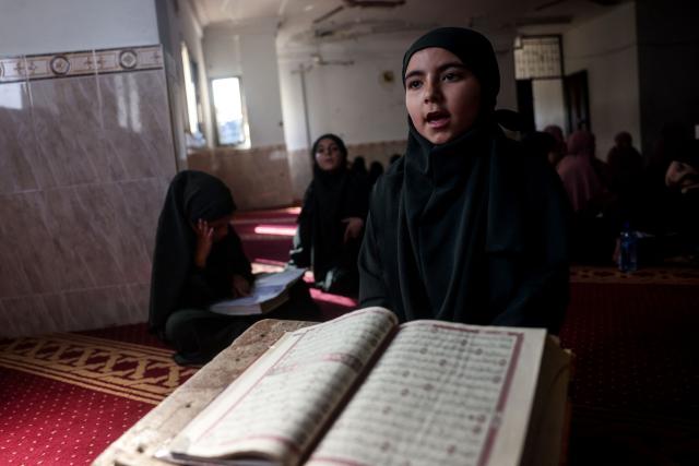 A Palestinian, one of the 470 Palestinian girls and young women attends a Quran recitation circle at the Al-Nour Quran Memorization Center following a long hiatus due to the war between the Israeli military and Palestinian Hamas militants, in Khan Yunis in the southern Gaza Strip on May 3, 2026. The Quran recitation study circle gathers the faithful around a teacher or a shared text for the purpose of learning, recitation, discussion, or spiritual development. The war on the Gaza Strip was sparked following the militant Palestinian group Hamas's October 7, 2023 attack on Israel, which resulted in the deaths of 1,221 people. Israel's retaliatory assault on Gaza has killed at least 72,600 people, according to figures from the health ministry that the UN considers reliable, with the majority of Gaza's 2.4 million people being displaced. (Photo by Bashar Taleb / AFP)