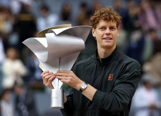 Italy's Jannik Sinner celebrates with the trophy after winning the 2026 ATP Tour Madrid Open tennis tournament final singles match against Germany's Alexander Zverev at the Caja Magica in Madrid, on May 3, 2026. (Photo by Oscar DEL POZO / AFP)