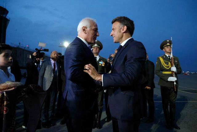France's President Emmanuel Macron is welcomed by Armenia's President Vahagn Khachaturyan at the airport upon his arrival for the 8th European Political Community (EPC) summit in Yerevan on May 3, 2026. (Photo by Ludovic MARIN / AFP)