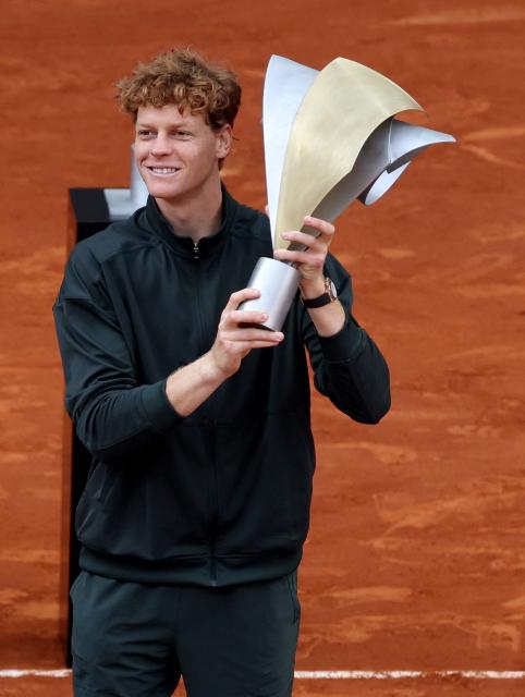 Italy's Jannik Sinner celebrates with the trophy after winning the 2026 ATP Tour Madrid Open tennis tournament final singles match against Germany's Alexander Zverev at the Caja Magica in Madrid, on May 3, 2026. (Photo by Thomas COEX / AFP)