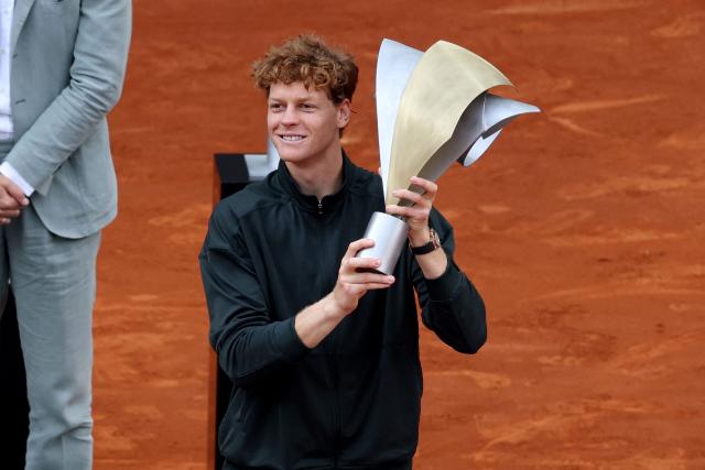 Italy's Jannik Sinner celebrates with the trophy after winning the 2026 ATP Tour Madrid Open tennis tournament final singles match against Germany's Alexander Zverev at the Caja Magica in Madrid, on May 3, 2026. (Photo by Thomas COEX / AFP)
