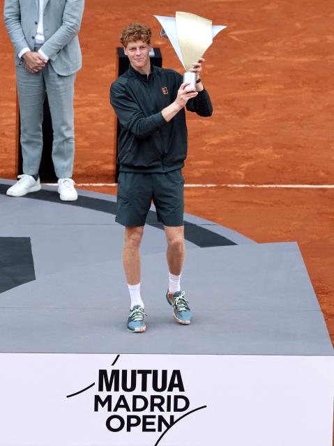 Italy's Jannik Sinner celebrates with the trophy after winning the 2026 ATP Tour Madrid Open tennis tournament final singles match against Germany's Alexander Zverev at the Caja Magica in Madrid, on May 3, 2026. (Photo by Thomas COEX / AFP)