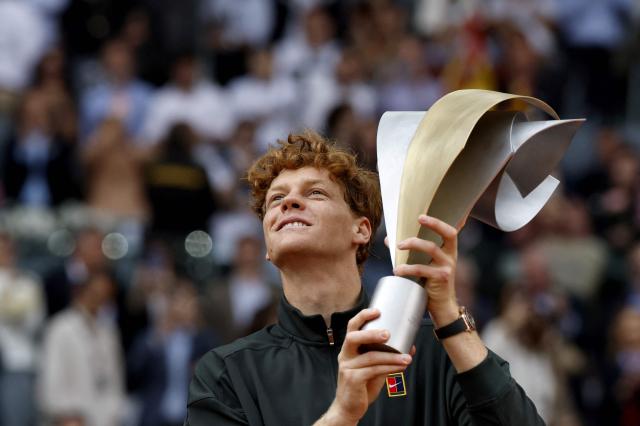 Italy's Jannik Sinner celebrates with the trophy after winning the 2026 ATP Tour Madrid Open tennis tournament final singles match against Germany's Alexander Zverev at the Caja Magica in Madrid, on May 3, 2026. (Photo by Oscar DEL POZO / AFP)