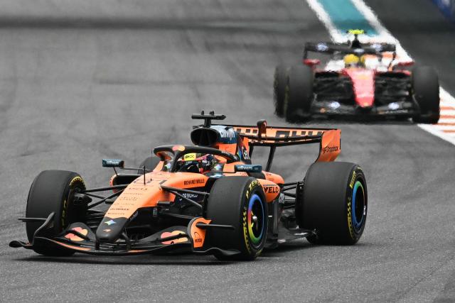 (L/R) McLaren's Australian driver Oscar Piastri and Ferrari's British driver Lewis Hamilton race during the 2026 Miami Formula One Grand Prix at Miami International Autodrome in Miami Gardens, Florida, on May 3, 2026. (Photo by CHANDAN KHANNA / AFP)