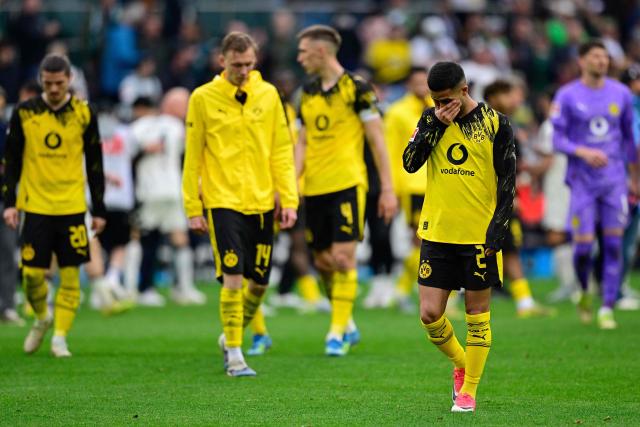 Dortmund's players including Brazilian defender #02 Yan Couto react after the German first division Bundesliga football match between Borussia Moenchengladbach and BVB Borussia Dortmund in Moenchengladbach on May 3, 2026. (Photo by INA FASSBENDER / AFP) / DFL REGULATIONS PROHIBIT ANY USE OF PHOTOGRAPHS AS IMAGE SEQUENCES AND/OR QUASI-VIDEO