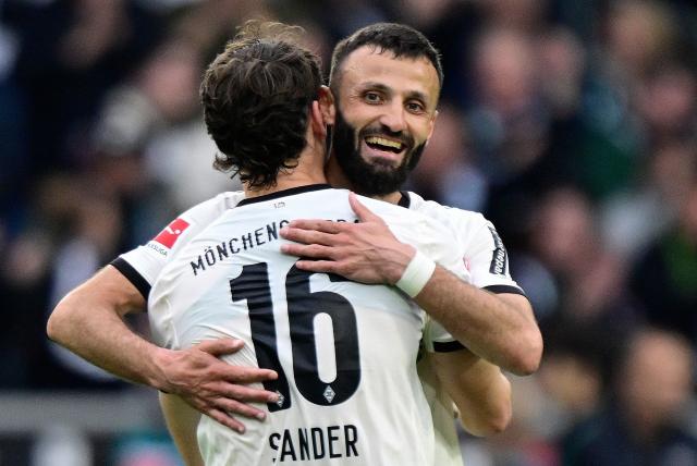 Moenchengladbach's German midfielder #16 Philipp Sander (L) and Moenchengladbach's French midfielder #09 Franck Honorat wmbarce after the German first division Bundesliga football match between Borussia Moenchengladbach and BVB Borussia Dortmund in Moenchengladbach on May 3, 2026. (Photo by INA FASSBENDER / AFP) / DFL REGULATIONS PROHIBIT ANY USE OF PHOTOGRAPHS AS IMAGE SEQUENCES AND/OR QUASI-VIDEO  ALTERNATIVE CROP