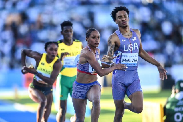 US' Bailey Lear (C) exchanges the baton with US' Jenoah McKiver (L) during the mixed 4x400m relay final during the Gaborone 26 World Athletics Relays at the National Stadium in Gaborone on May 3, 2026. (Photo by AFP)