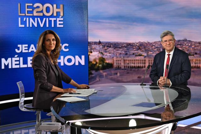 La France Insoumise (LFI) leader Jean-Luc Melenchon (R) poses ahead of an interview by journalist Anne-Sophie Lapix on the French TV channel TF1's evening news program where he announced his candidacy for the 2027 French presidential election in Boulogne-Billancourt, outside Paris, on May 3, 2026. (Photo by Julie SEBADELHA / AFP)