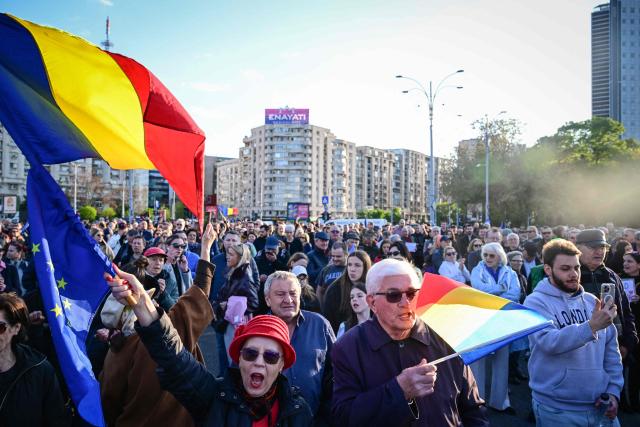 Supporters of Prime Minister Ilie Bolojan gather in Victoria Square, in front of the Romanian Government headquarters, on May 3, 2026, to demonstrate their backing for his minority government. The rally comes as the pro-EU leader faces a critical no-confidence vote scheduled for May 5, following the withdrawal of support from the nationalist-sovereignist AUR party and Social Democratic Party (PSD). Demonstrators, carrying Romanian and European Union flags, are calling for the continuation of Bolojans fiscal reforms and the stability of the current cabinet. (Photo by Daniel MIHAILESCU / AFP)