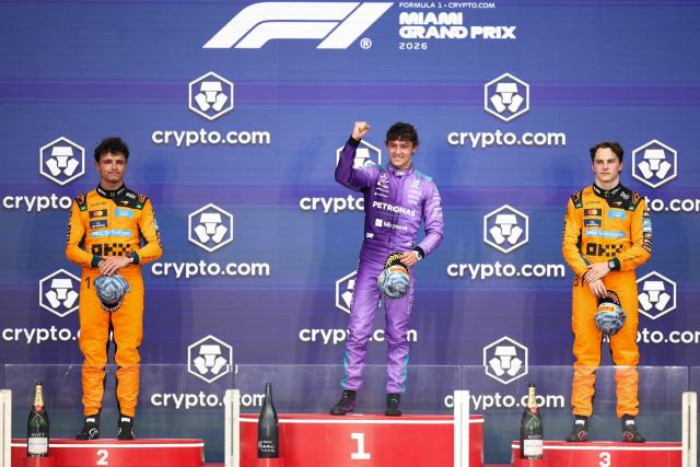 Race winner Mercedes' Italian driver Kimi Antonelli (C) celebrate on the podium alongside second place finisher McLaren's British driver Lando Norris (L) and third place finisher McLaren's Australian driver Oscar Piastri (R) after the 2026 Miami Formula One Grand Prix at Miami International Autodrome in Miami Gardens, Florida, on May 3, 2026. (Photo by CHARLY TRIBALLEAU / AFP)