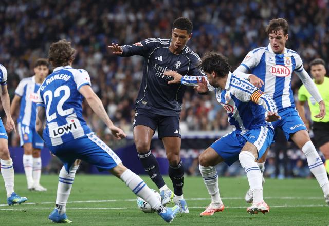 Real Madrid's English midfielder #05 Jude Bellingham fights for the ball with Espanyol's Spanish defender #22 Carlos Romero (L) and Espanyol's Uruguayan defender #06 Leandro Cabrera during the Spanish league football match between RCD Espanyol and Real Madrid CF at RCDE Stadium in Cornella de Llobregat on May 3, 2026. (Photo by Josep LAGO / AFP)