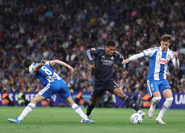 Real Madrid's English midfielder #05 Jude Bellingham fights for the ball with Espanyol's Spanish midfielder #08 Edu Exposito (L) and Espanyol's Spanish midfielder#04 Urko Gonzalez during the Spanish league football match between RCD Espanyol and Real Madrid CF at RCDE Stadium in Cornella de Llobregat on May 3, 2026. (Photo by Josep LAGO / AFP)