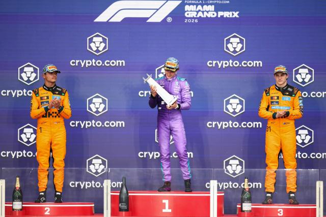 Race winner Mercedes' Italian driver Kimi Antonelli (C) celebrates on the podium alongside second place finisher McLaren's British driver Lando Norris (L) and third place finisher McLaren's Australian driver Oscar Piastri (R) after the 2026 Miami Formula One Grand Prix at Miami International Autodrome in Miami Gardens, Florida, on May 3, 2026. (Photo by CHARLY TRIBALLEAU / AFP)