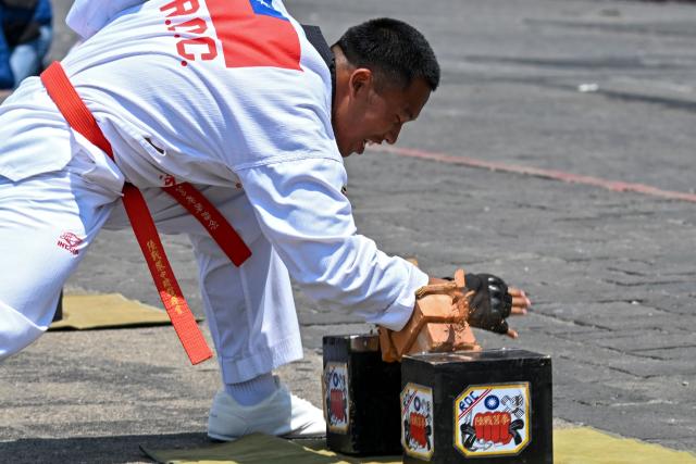 A Navy cadet from a friendship squadron from Taiwan performs martial arts at Constitution Square in Guatemala City on May 3, 2026. The three vessels -- described as being on a training mission -- powered into Puerto Quetzal, a port town on Guatemala's Pacific coast, in a visit "to strengthen the ties of friendship," Guatemalan officials and Taiwanese diplomats said. (Photo by JOHAN ORDONEZ / AFP)