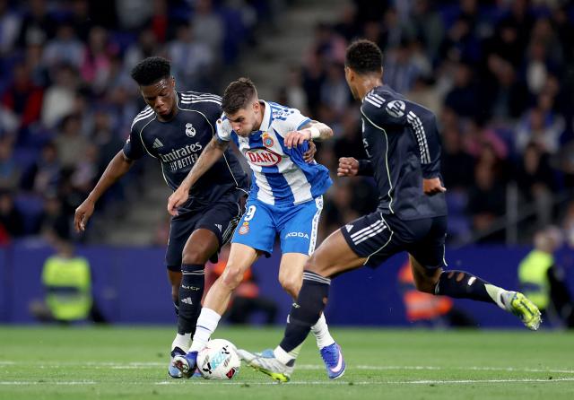 Espanyol's Spanish forward #09 Roberto Fernandez fights for the ball with Real Madrid's French midfielder #14 Aurelien Tchouameni and Real Madrid's English midfielder #05 Jude Bellingham during the Spanish league football match between RCD Espanyol and Real Madrid CF at RCDE Stadium in Cornella de Llobregat on May 3, 2026. (Photo by Josep LAGO / AFP)