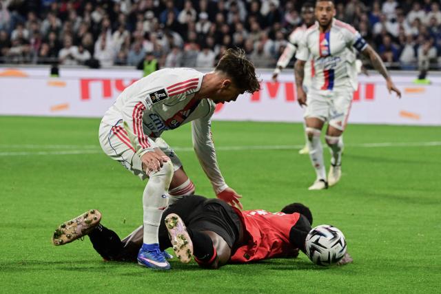 Rennes' Swiss forward #07 Breel Embolo falls as he fights for the ball with Lyon's Portuguese forward #17 Afonso Moreira (L) during the French L1 football match between Olympique Lyonnais (OL) and Stade Rennais FC at the Groupama Stadium in Decines-Charpieu, central-eastern France on May 3, 2026. (Photo by OLIVIER CHASSIGNOLE / AFP)