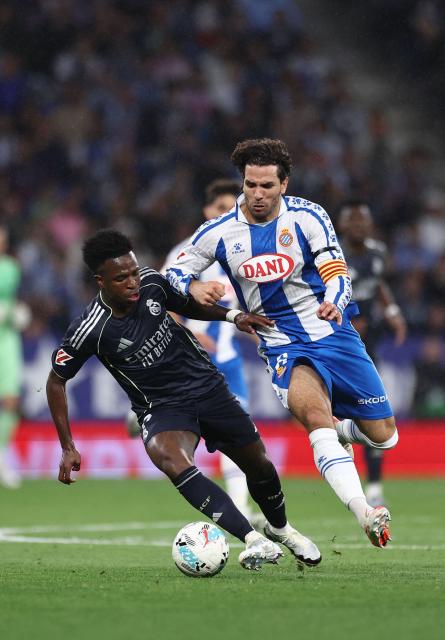 Real Madrid's Brazilian forward #07 Vinicius Junior fights for the ball with Espanyol's Uruguayan defender #06 Leandro Cabrera during the Spanish league football match between RCD Espanyol and Real Madrid CF at RCDE Stadium in Cornella de Llobregat on May 3, 2026. (Photo by Josep LAGO / AFP)