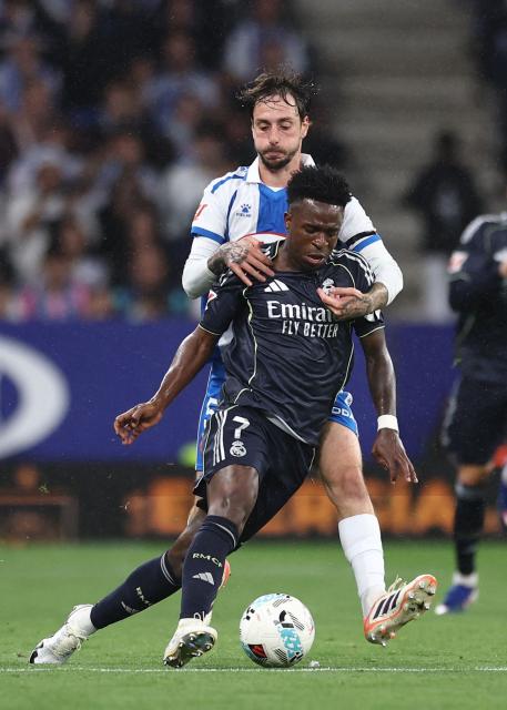 Real Madrid's Brazilian forward #07 Vinicius Junior fights for the ball with Espanyol's Spanish defender #05 Fernando Calero during the Spanish league football match between RCD Espanyol and Real Madrid CF at RCDE Stadium in Cornella de Llobregat on May 3, 2026. (Photo by Josep LAGO / AFP)