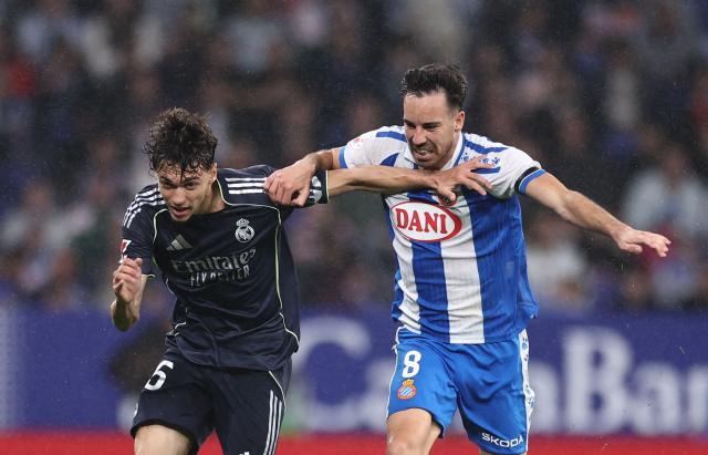Real Madrid's Spanish midfielder #45 Thiago Pitarch fights for the ball with Espanyol's Spanish midfielder #08 Edu Exposito during the Spanish league football match between RCD Espanyol and Real Madrid CF at RCDE Stadium in Cornella de Llobregat on May 3, 2026. (Photo by Josep LAGO / AFP)