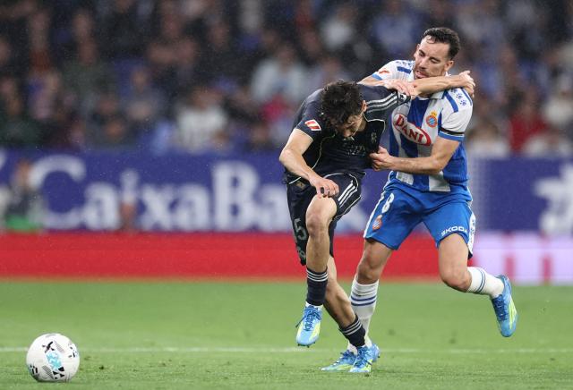Real Madrid's Spanish midfielder #45 Thiago Pitarch fights for the ball with Espanyol's Spanish midfielder #08 Edu Exposito during the Spanish league football match between RCD Espanyol and Real Madrid CF at RCDE Stadium in Cornella de Llobregat on May 3, 2026. (Photo by Josep LAGO / AFP)