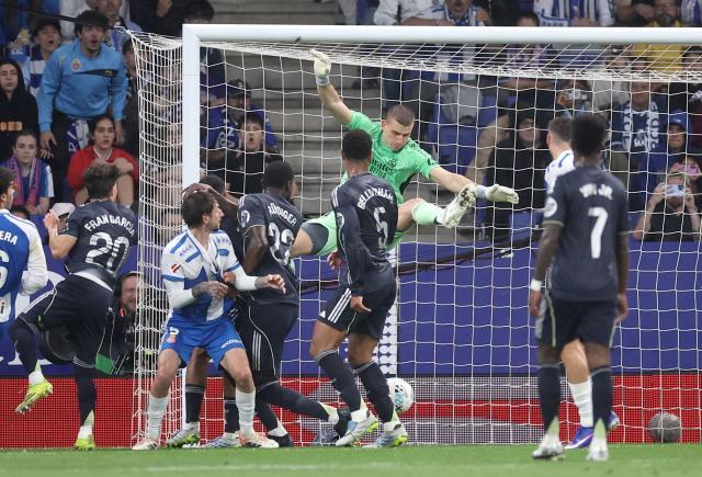Real Madrid's Ukrainian goalkeeper #13 Andriy Lunin jumps for the ball during the Spanish league football match between RCD Espanyol and Real Madrid CF at RCDE Stadium in Cornella de Llobregat on May 3, 2026. (Photo by Josep LAGO / AFP)
