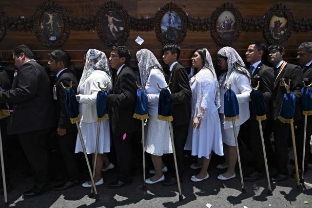 Catholic faithful carry an image of the Virgin of the Rosary during a procession as part of the "Feast of the Rose" in Guatemala City on May 3, 2026. (Photo by JOHAN ORDONEZ / AFP)