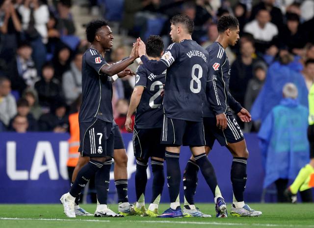 Real Madrid's Brazilian forward #07 Vinicius Junior (L) celebrates scoring his team's first goal with teammates during the Spanish league football match between RCD Espanyol and Real Madrid CF at RCDE Stadium in Cornella de Llobregat on May 3, 2026. (Photo by Josep LAGO / AFP)