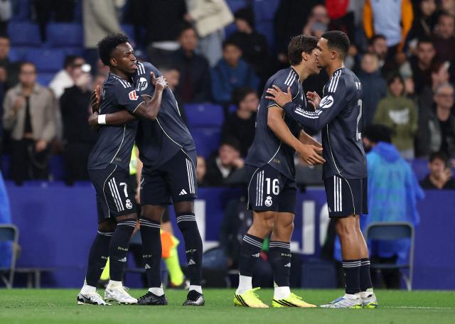 Real Madrid's Brazilian forward #07 Vinicius Junior (L) celebrates scoring his team's first goal with teammates during the Spanish league football match between RCD Espanyol and Real Madrid CF at RCDE Stadium in Cornella de Llobregat on May 3, 2026. (Photo by Josep LAGO / AFP)