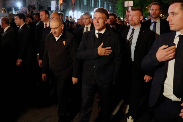 France's President Emmanuel Macron and Armenia's President Vahagn Khachaturyan walk on a street after a diner on the eve of the 8th European Political Community (EPC) summit in Yerevan on May 3, 2026. (Photo by Ludovic MARIN / AFP)