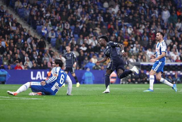 Real Madrid's Brazilian forward #07 Vinicius Junior (C) scores his team's first goal during the Spanish league football match between RCD Espanyol and Real Madrid CF at RCDE Stadium in Cornella de Llobregat on May 3, 2026. (Photo by Josep LAGO / AFP)