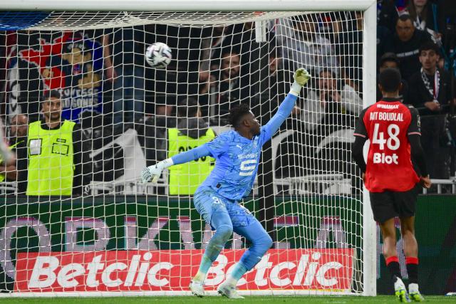 Rennes' French goalkeeper #30 Brice Samba (L) stretches unsuccessfully for the ball as he concedes Lyon's fourth goal during the French L1 football match between Olympique Lyonnais and Rennes at the Groupama Stadium in Decines-Charpieu, central-eastern France, on May 3, 2026. (Photo by OLIVIER CHASSIGNOLE / AFP)