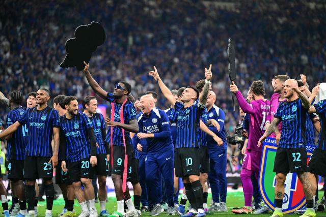 Inter Milan's French forward #9 Marcus Thuram and Inter Milan's Argentinian forward #10 Lautaro Martinez celebrate with teammates after winning the 21st 'scudetto' following the Italian Serie A football match between Inter Milan and Parma at San Siro stadium in Milan, on May 3, 2026. (Photo by Stefano RELLANDINI / AFP)