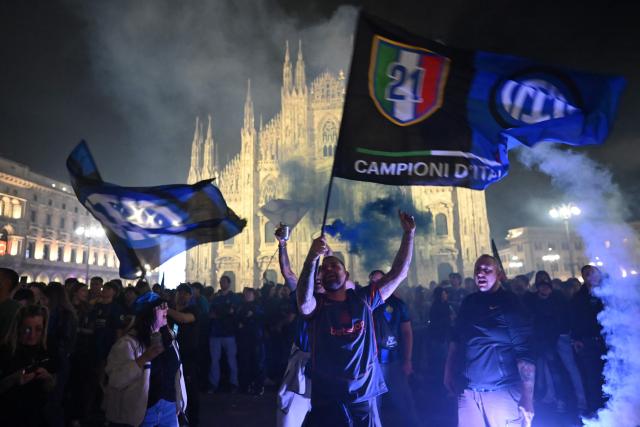 TOPSHOT - Inter Milan’s supporters celebrate at Piazza Duomo after their team clinched their 21st scudetto following the Italian Serie A football match between Inter Milan and Parma, in Milan, on May 3, 2026. (Photo by PIERO CRUCIATTI / AFP)