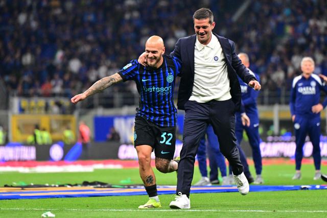 Inter Milan's Romanian head coach Cristian Chivu and Inter Milan's Italian defender #32 Federico Dimarco celebrate after winning their 21st 'scudetto' following the Italian Serie A football match between Inter Milan and Parma at San Siro stadium in Milan, on May 3, 2026. (Photo by Stefano RELLANDINI / AFP)